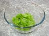 Порвите на небольшие кусочки листья салата и положите их в миску.
