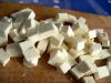 Добавьте нарезанный кубиками адыгейский сыр. И дайте ему пару минут поджариться, периодически помешивая.