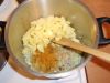 Картошку помойте, почистите и добавьте к луку. Обжарьте до золотистого цвета. Добавьте специи и соль.